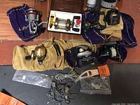 All seven reels laid out with extra hooks and clips