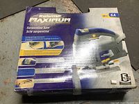 Full view of unopened box showcasing Mastercraft Maximum serpentine saw. Blue and gray saw pictured with yellow accents. Box shows model number 6A and indicates 18 piece set.