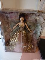 Front view of unopened Barbie Couture Angel doll in original box showing doll in pink and gold gown with angel wings.
