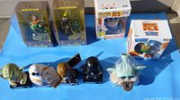 Photo showing Star Wars vinyl figures including Yoda, Darth Vader, Baby Yoda, and others, alongside boxed Funko Pops and Dorbz collectibles of Minions characters.