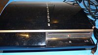 Top view of PlayStation 3 fat console showing glossy black finish with logo