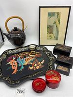 Full set of Asian style items including black ceramic tea pot, lacquer tray, lacquer boxes, red round containers, and framed print.