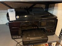 Front and top view of an HP Officejet Pro 8500A printer showing control panel, display screen, paper output tray, and automatic document feeder.