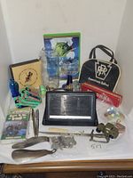 Full overview photo of the lot showing all items including the railroad bag, glassware, shoe stretchers, marbles, and small accessories.