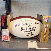 Football in display box showing full autograph and inscription by Vince Papale.