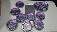 Purple mosque-themed decorative cake plates arranged around a purple and gold patterned tablecloth.