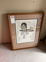 Framed and matted print in oak frame showing full artwork of Indigenous woman with child.