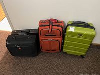 Group shot of four luggage items against wall