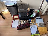 Wide shot showing full lot contents including shredder, printer, cassette/radio, various office items, and organizers on floor.