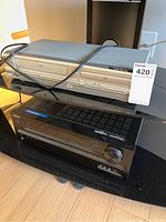 Side view showing the stacked ONKYO AV receiver below and the silver SV2000 DVD/VCR player on top with cables.