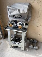 Overall shot of Hoist adjustable dumbbell system on stand with two pairs of fixed hex dumbbells.