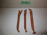 Three J. Marttiini fishing knives in brown leather sheaths, showing size and sheath design.