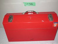 Front view of large red metal toolbox closed with metal latches, handle and Canadian flag sticker