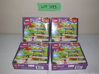 Four sealed Lego Friends sets 41098 displayed with front cover showing Emma and flower stand.