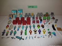 Full view of Minecraft toy lot including characters, blocks, animals, mobs, and tools.