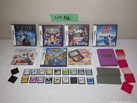 Full overview of the lot shows 4 Nintendo DS game cases, 1 Nintendo 3DS game case, 19 loose DS cartridges, 4 small cartridge cases and a larger purple game cartridge storage case.