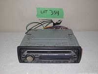 Photo of front view of black Sony car audio system model CDX-GT200 with CD player slot and control buttons, showing front panel details.