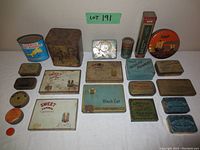 All vintage tins arranged on a flat surface, showing most of the lot including rectangular, square, and round tins with various advertising graphics and logos.