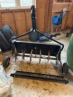 Aerator and dethatcher attachments mounted on SmartLINK master platform in garage