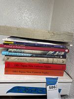 Shelf with an assortment of eleven books showing various cover colors and titles focusing on art, nature, and cultural studies.
