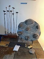 Overall view of metal leaf sculpture and stone fossil slab