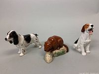 Three porcelain animal figurines include a Beswick beaver, a Royal Doulton Setter dog, and a Beagle figurine. Beagle shows chips.