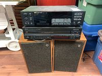 Full view of Yamaha K-720 Stereo Cassette Deck on top, Denon DCM-460 CD Player below, sitting on a wooden surface, with a pair of NORESCO NE-521 speakers in front on the floor.