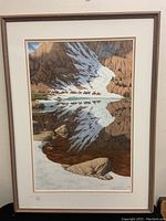 Full view of the framed print showing the mountain and horse riders scene with snow and reflection in water.