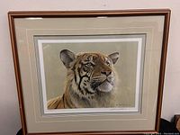 Framed print of a tiger by Robert Bateman, visible signature and edition number on the mat, wooden frame with some minor wear on upper edge.
