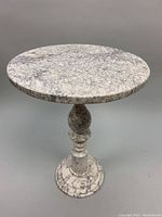 Front view of round marble accent table showing overall shape and finish