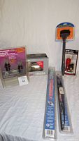 Overview photo showing all items in lot including the halogen bulbs, windshield wipers, trouble light, microfiber cleaner, and power adaptors.