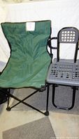 Green fabric and gray plastic folding camp chairs side by side, showing front view