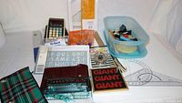 Wide view of the full lot showing calculator, ruler, clip containers, pens, protractor, and mini constructor case, pencil case, and other office supplies.