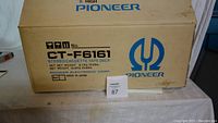 Cardboard shipping box labeled Pioneer CT-F6161 with net weight and origin details.