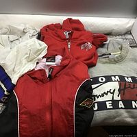 Four athletic wear sweatshirts laid out showing front logos and colors