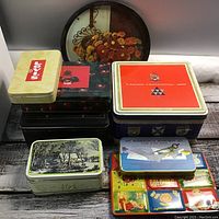 Top view of assorted cookie tins stacked with round floral tray behind