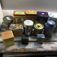 Frontal group photo of all coffee and tea tins showing various sizes, colors, and vintage styles.