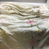 Full view of the vintage floral design bedspread showing texture and floral patterns.