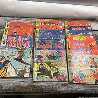 Photo of 13 vintage comics from Archie series including Mad About Millie, Reggie's Me, Josie, Jughead, and others.