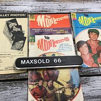 Four vintage The Monkees comics with colorful covers and a Monkee Wallet Photos packet showing black and white portraits of band members.