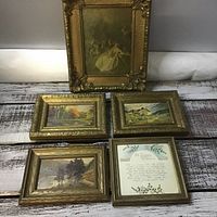 Overview of all five vintage pictures arranged on a rustic wooden surface, showing size and frame styles.