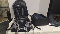 Photo of three backpacks placed on a white surface with two High Sierra backpacks and one black and blue laptop backpack