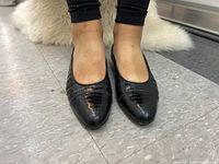 Front-on view of flats being worn, showing toe shape and fit