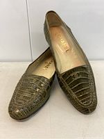 Pair of loafers stacked showing top and front