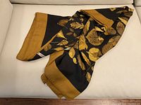 Folded shawl showing ochre border and Hermès Paris label