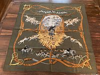 Full view of scarf laid flat showing entire hunting scene and border
