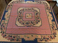 Full view of shawl laid flat on table showing overall design and coloration