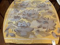 Full shawl laid flat showing overall lotus flower pattern and border