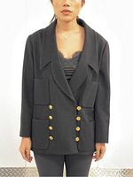Front view of black Chanel cashmere blazer on model