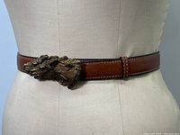 Full view of belt on mannequin showing overall design, color, and buckle